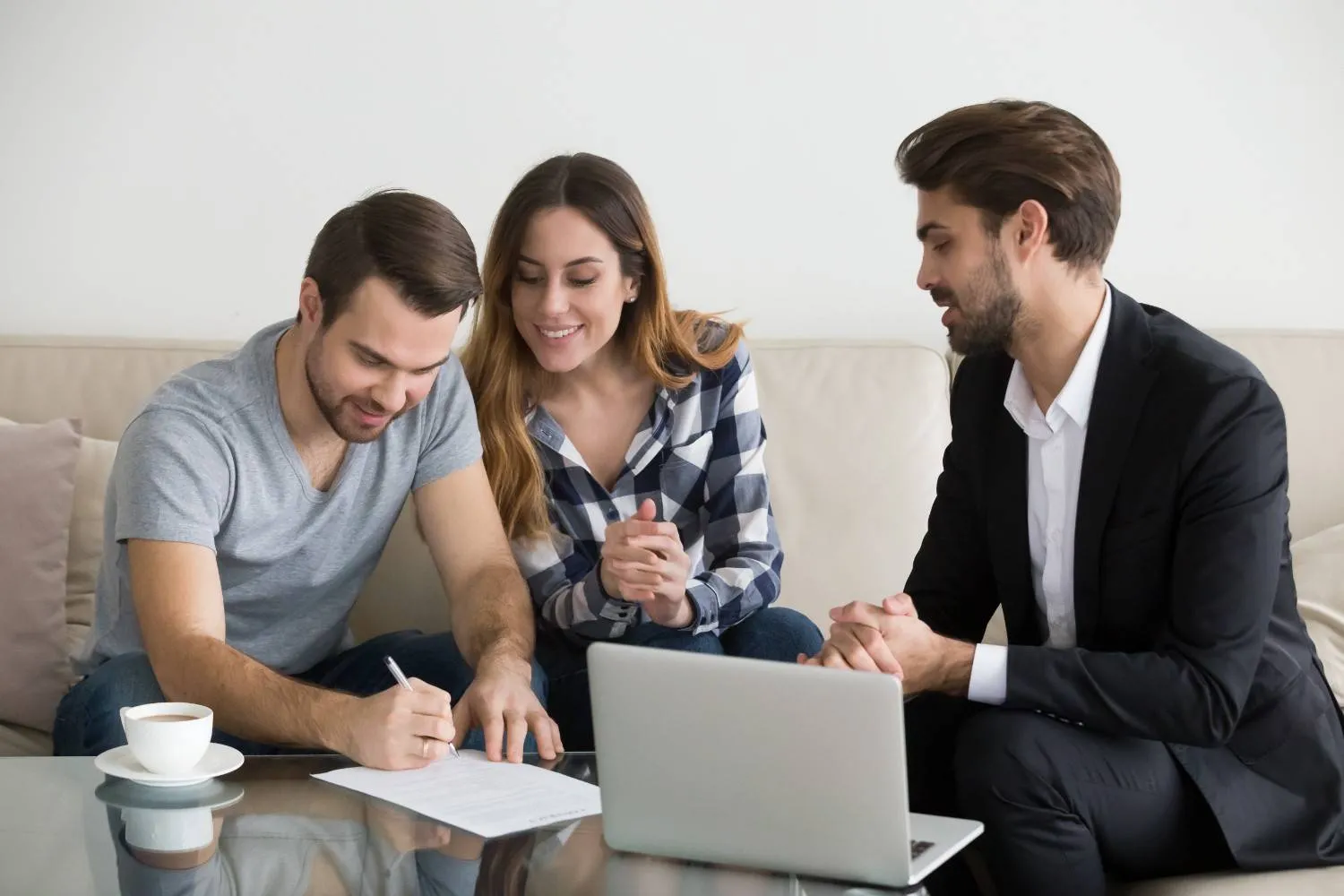 Two business owners going over paperwork on a laptop with a client