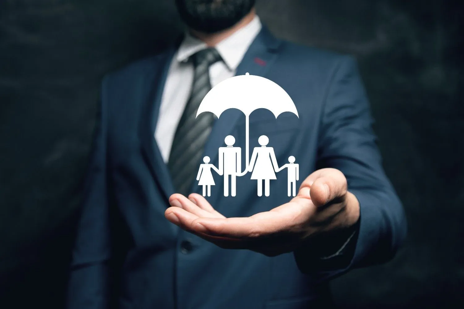 Hand holding a protective umbrella over a family, representing insurance cover
